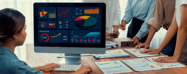 Fototapete - Panorama shot analyst team utilizing BI Fintech to analyze financial report with laptop. Businesspeople analyzing BI power dashboard displayed on laptop screen for business insight. Scrutinize