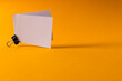 White business cards with paperclip and copy space on orange background