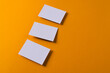 White business cards with copy space on orange background