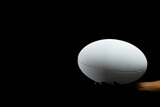 Fototapeta Desenie - White rugby ball with copy space on black background