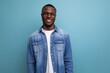 kind friendly young american man in denim clothes on blue background with copy space