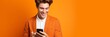 © wolfhound911 - Man with phone on orange background. AI Generated