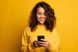 Leinwandbild Motiv woman with phone on yellow background . AI Generated