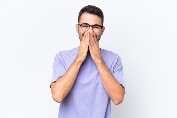 Sticker - Young caucasian man isolated on white background happy and smiling covering mouth with hands