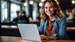 © Ron Dale - Young woman working on laptop, girl freelancer or student with computer in cafe at table, looking in camera. Model by AI generative