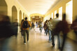 Blurred shot of high school students walking up the strs between classes in a busy school building,