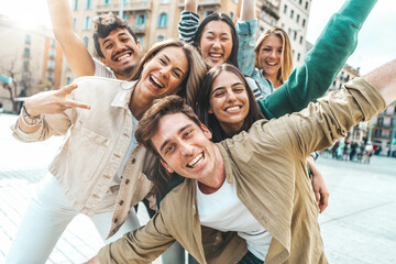 Multiracial best friends having fun outside - Group of young people smiling at camera outdoors - Friendship concept with guys and girls hanging out on city street	