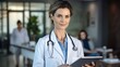 © visoot - Portrait of beautiful mature woman doctor holding digital standing at hospital.