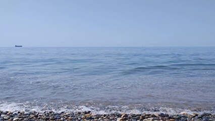 Poster - Sea pebble shore on a bright sunny day.