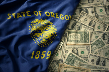 Wall Mural - colorful waving national flag of oregon state on a american dollar money background. finance concept