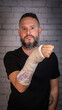 © Jess - Young man with beard and without glasses, wearing a black T-shirt. Broken arm with plaster painted with children's drawings. Tenerife, Canary Islands, Spain.