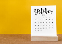The October 2023 Monthly Calendar For 2023 Year On Yellow Table.