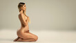 Pregnant woman holding her belly, sitting naked . Profile view. A lot of copy space. Pregnancy concept.