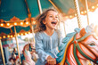 A happy young girl expressing excitement while on a colorful carousel, merry-go-round, having fun at an amusement park