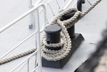 Tied Rope On The Knot Around The Mooring Bollard. Nautical Theme Background