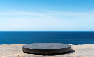 Empty round black podium on stone platform with sea and blue sky background for product display