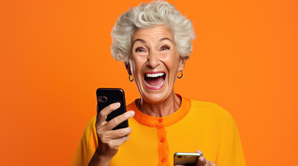 Wall Mural - An elderly woman exited and shocked as she saw something on her phone against an orange background.