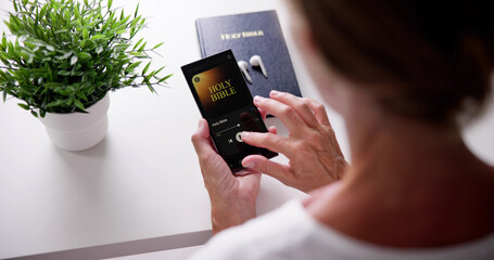 Wall Mural - Christian Woman Reading Bible Book On Phone