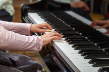 A Child Learns To Play The Piano In The Lessons At A Music School.