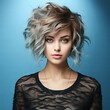 Fashion portrait of beautiful young woman with short hairstyle and professional make up. Beautiful fashion model with stylish hairstyle, studio shot. Fashion model in blue clothes with bright makeup