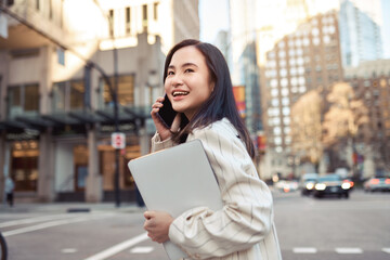 young busy happy asian business woman office professional holding cellphone in hands walking on big 