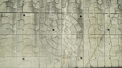 Tiled old wall background texture with a circular pattern in the center