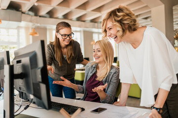 young women working on a project together in a startup company office