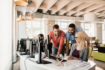 Young people working together on a project in a startup company office