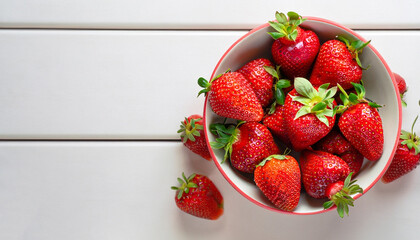 Wall Mural - Strawberries in bow on white table top view. Beautiful red strawberry