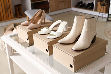 Wall Mural - Table with stylish female shoes in boutique, closeup