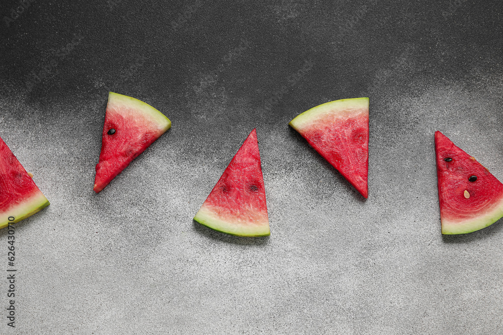 Composition with pieces of ripe watermelon on grey background