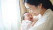 © Sasint - Adorable newborn baby smile and relax in mother arm safety and comfortable.Healthy Asian newborn infant baby laughing with happiness good moment.Mother holding infant baby.Newborn Baby concept
