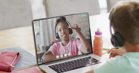 Poster - Caucasian schoolboy on laptop online learning with african american schoolgirl