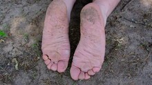 Close Up Of Slightly Dirty Feet Sole While Laying On The Ground.