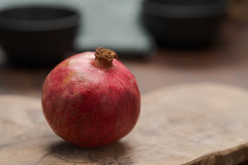 Wall Mural - Ripe small pomegrenate on olive wood board