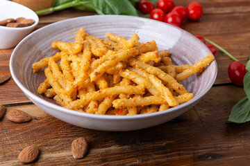 Wall Mural - Sicilian pasta with almond and tomatoes pesto. Typical Italian food from Sicily, pasta with red pesto.