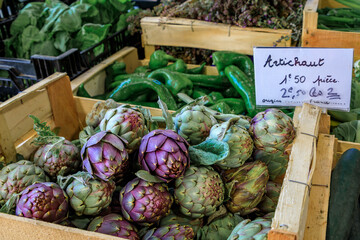 Sticker - Fresh purple artichokes with a price tag of 2.5 Euro each at a local provencal farmers market hall in the old town or Vieil Antibes, South of France