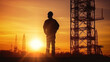 Silhouette of Engineer checking project at building site background, construction site at sunset in evening time.
