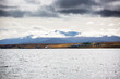 Panoramic landscape in Patagonia with sea and mountains and cloudy sky, Puerto Natales, Chili