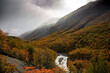 Sun through cloudy sky over mountains in autumn,  W Trek in Torres Del Paine, Patagonia, Chili