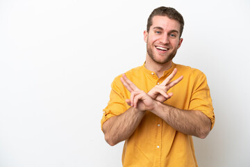 Wall Mural - Young caucasian man isolated on white background smiling and showing victory sign