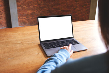 Wall Mural - mockup image of a woman using and touching on laptop computer touchpad with blank white desktop scre
