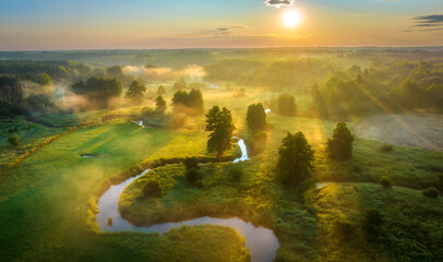 Wall Mural - beautiful summer sunrise over the river covered with morning fog