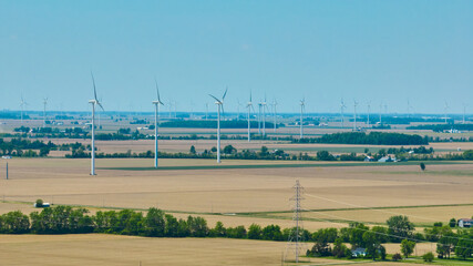 Wall Mural - Wind farm aerial with power lines on summer day