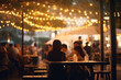 © serperm73 - Street cafe, restaurant, evening. Illumination bokeh and defocused people sit at tables.