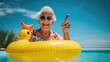 An elderly woman swims in a pool on a yellow inflatable duckling over the weekend.