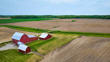 Red Barn, Shed Buildings On Farm Property Tilled Plowed Empty Fields Aerial Winding Runoff Ditch