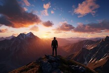Hiker At The Summit Of A Mountain Overlooking A Stunning View. Apex Silhouette Cliffs And Valley Landscape At Sunset.