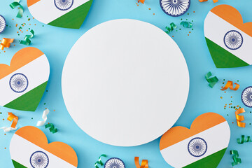 Wall Mural - Have a fantastic India Independence Day. Top view shot of paper indian hearts, ashoka wheels, confetti on pastel blue background with blank circle for ads or text