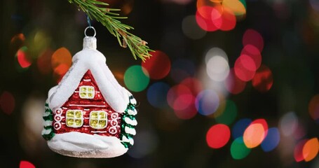 Aufkleber - Christmas tree decorated red toy house, Fir branch with red toy house and festive lights on the Christmas background with sparkles and bokeh